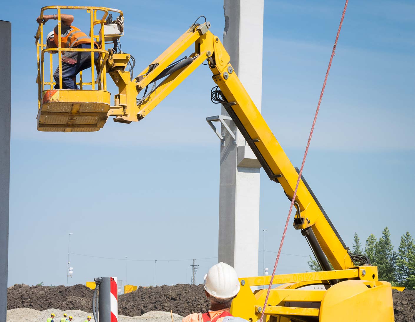 Arbeiter in Hebebühne bei Bauarbeiten